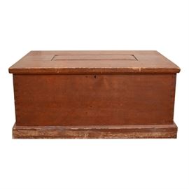 Antique Handmade Pine Chest: An antique handmade pine chest. The hinged top features a beveled rectangular inset panel and mitered corners. The chest has dovetail joints and rests on a framed base. There is a small keyhole escutcheon to front, key is not present.