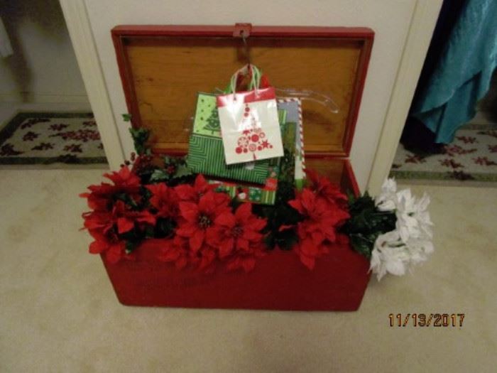 Holiday florals and gift bags.  Great Wooden Chest for decorating and storage.  