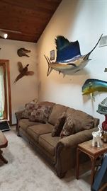 sofa and taxidermy fish and bird