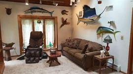 living space with sofa, massage chair, taxidermy and more