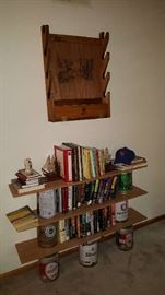 Books and media with gun rack above