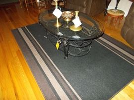 rug, glass coffee table, brass candlesticks