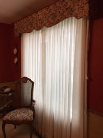 Custom made pinch pleated sheers underneath padded cornice that matches chair fabric. Cornice is 6 feet wide.