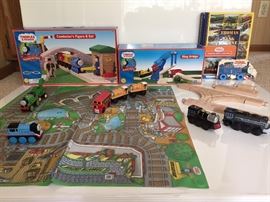 Thomas and Friends Wooden Railway. Conductor's figure 8 Set. Sling Bridge, Add on sets of railway, Thomas, Percy, Ben, Bill, and Alfie. Two sided mat. Hard cover books of Thomas and friends. All compatible with addition train track in wooden box. Additional trains. All sold separately.