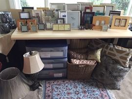 Many picture frames to choose from. Two modern office tables 66" X 31" with cutout for electrical chords. Drawers are filled with greeting cards, stationary/ book covers, and office supplies. Small hand knotted Kashan rug.