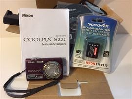 Nikon Coolpix S220 digital camera with case and extra battery. In original packaging.