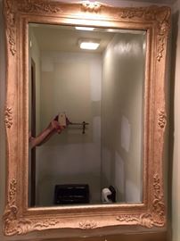 Elaborate cast plaster framed beveled mirror. 43" x 31".