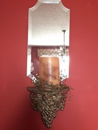 Pair of sconces with mirror, and beaded garland around candle.