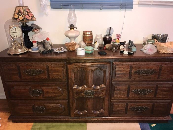 Bedroom dresser with assorted collectibles and home decor