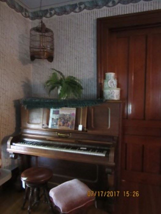 Wegman Pianos were made in Auburn and are very well made Pianos.  This one is in good condition.  Above the piano is a wood bird cage.  Piano stool is also pictured. 