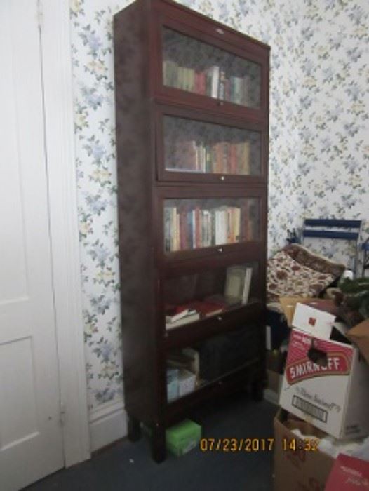 5 stacking bookcases all with doors that open and close.  