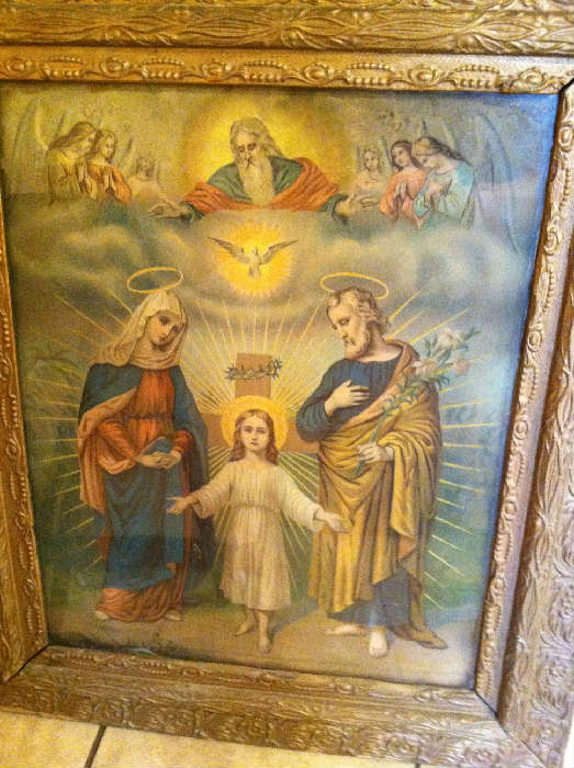 Antique religious pictures in antique picture frames.