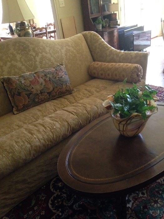 Fabulous gold sofa, oval coffee table, and glass art bowl