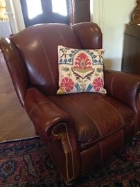 Good-looking brown leather recliner & decorative pillow