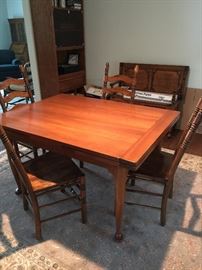Cherry dining room table - 46" x 40".  Has self storing leaves.