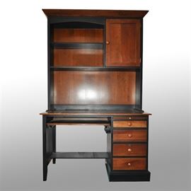 Ethan Allen American Impressions Desk With Hutch: A contemporary Ethan Allen wooden desk with hutch. The desk features a sliding hideaway keyboard shelf along with an expandable side shelf, two small drawers, and a larger lockable filing cabinet drawer. The drawers feature dovetail joinery. The hutch features two shelves along with a side cabinet that contains additional storage.