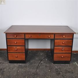 Ethan Allan Desk: An Ethan Allen wooden desk. This wooden desk has a smooth, glossy top with black accents and rounded handles on the rectangular drawers. It stands on solid feet and has three drawers that lock and comes with the appropriate keys.