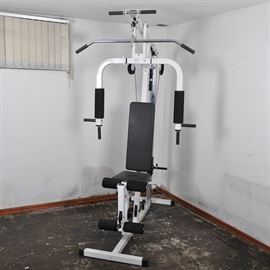 Universal Gym Work Out Equipment: A universal gym piece of work out equipment. This gym is capable of assisting with chest, back, and leg extension exercises. No weights are included.