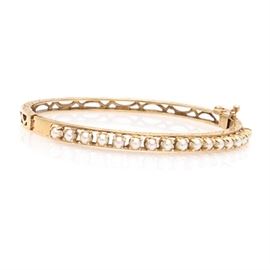 14K Yellow Gold Cultured Pearl Bangle: A 14K yellow gold cultured pearl bangle bracelet.