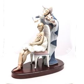 Signed Limited Edition Lladró "Jester's Serenade" #5932: A Lladró figurine titled Jester’s Serenade, #5932. The piece depicts a Harlequin playing his violin for his Columbine, she is dressed as a ballerina and clutching a bouquet of flowers to her chest. The piece was sculpted by Antonio Ramos and limited to 3000 pieces. The piece was issued in 1993 and retired in 1994. The piece is signed by J. Ruiz and Antonio Ramos, numbered “N-65”.