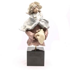 Lladró Limited Edition "Maggie" # 1751 by Enrique Sanisidro: A Lladró limited edition sculpture titled Maggie. The unfinished look matte sculpture was done by Enrique Sanisidro and issued in 1991, retired in 1992. The piece was one of a three hundred, it is rare. The piece is displayed on a pole and a black lacquered cube stand. The piece is signed by the artist and numbered to the interior.