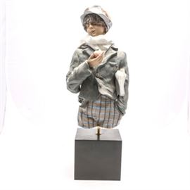 Lladró Limited Edition "Apple Seller" #1752 by Enrique Sanisidro: A Lladró figurine titled Apple Seller, #1752. The piece was originally sculpted by Enrique Sanisidro and depicts a boy in an unfinished style, in matte bisque. The piece is a limited edition of 300, issued in 1991 and retired in 1992. The piece is signed and numbered to the interior.