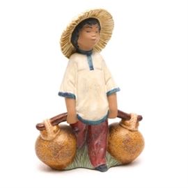 Lladró Signed Figurine "Chinese Boy" #2153: A Lladró signed figurine titled Chinese Boy, #2153. The boy is dressed in traditional Chinese clothing, carrying two water jugs. The piece is of the gres finish. The figurine was originally sculpted by José Puche and was issued in 1985 and later retired in 1990. The piece is signed “M. Lladro” to underside and dated “9/17/86”.