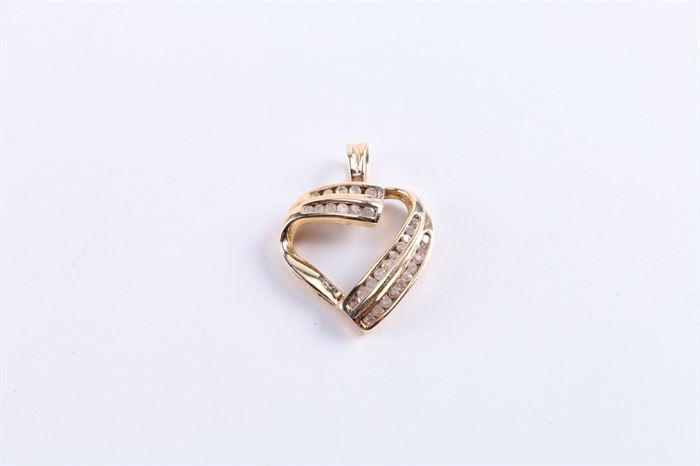 10K Diamond Heart Shaped Pendant: A 10K diamond heart shaped pendant.