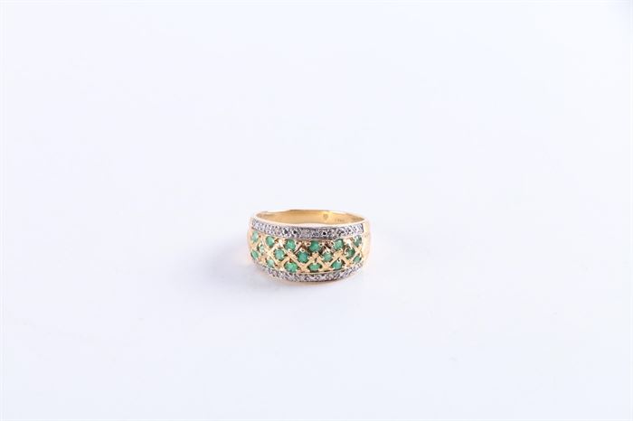 14K Yellow Gold Emerald and Diamond Ring: A 14K yellow gold emerald and diamond ring. This ring features seventeen faceted round cut emeralds encased in gold diamond shaped frames with two rows of three diamonds to each side.