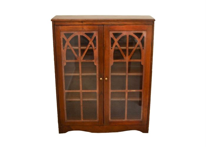 Vintage Mahogany Bookcase with Glass Doors: A vintage mahogany bookcase. This unit features glass-front doors, with decorative applied wood banding, in an arch and sectional window-style design; three interior shelves, and brass-tone hardware.