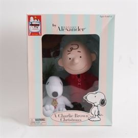 Madame Alexander "A Charlie Brown Christmas" Doll: A Charlie Brown Christmas doll by Madame Alexander and Peanuts TV Classics by Schultz. This handcrafted porcelain doll depicts a smiling Charlie Brown with his brown hat next to a Christmas tree and a plush Snoopy. Presents unopened in its original box.