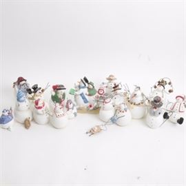 Collection of Sandi Gore Evans "Frosty Follies" Figurines: A collection of seventeen Frosty Follies snowman figurines by Sandi Gore Evans. Includes Mama Loves Mambo, S’mores, Snow Buddies, Snowman with Sled, Mistletoe, Snow Angel, and many more. Items feature a hand painted resin construction.