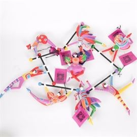 Set of Department 56 Cirque Du Soleil Ornaments: A collection of eight Cirque Du Soleil ornaments by Department 56. Each depicts an acrobat in a different pose, hand-painted using vibrant rainbow hues. The acrobats are mounted to a black bar and present with original Cirque De Soleil tags.