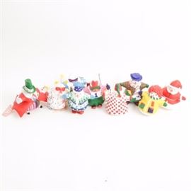 Department 56 "Snow Attire" Ornaments: A collection of nine Snow Attire ornaments by Department 56. Each features a handcrafted resin composition and depicts a different character including Holding Candles, Plaid Shirt, Sweater Man, Beach Bum, Downhill King, Masquerade Party, Santa Snowman, Showshoer w/Parka, and Top Hat Tuxedo. All are hand-painted using vibrant rainbow hues and present in original boxes.