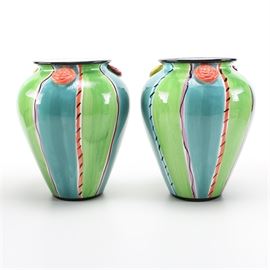 Pair of Vases by Blue Ridge Designs INC.: A pair of slipcast and hand-painted vases by Blue Ridge Designs INC. They each feature a vibrant underglaze with clear gloss finish hues of green, blue and red with black accents. Marked on the bottom “Blue Ridge Designs Inc.”