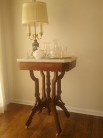 Eastlake burl walnut marble top table with porcelain wheels...vintage lamp...cut glass..marble dish with lid