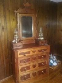 Eastlake dresser..walnut ..solid burl walnut. Original brass and teardrop wood pulls. Two top drawers over four graduated drawers..mirror with crown and wood "tassels" on sides