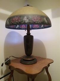 HANDEL LAMP...shade with upper part solid yellow and lower part a rim of roses and blossoms....with colors blue..red..white..yellow..green...black..

