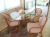 RATTAN TABLE & 4 CASTOR CHAIRS