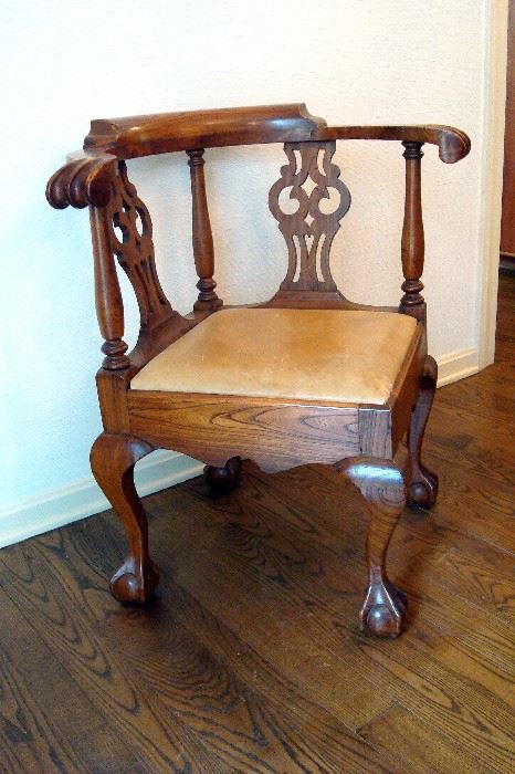 Antique Chippendale mahogany corner chair with ball and claw feet.