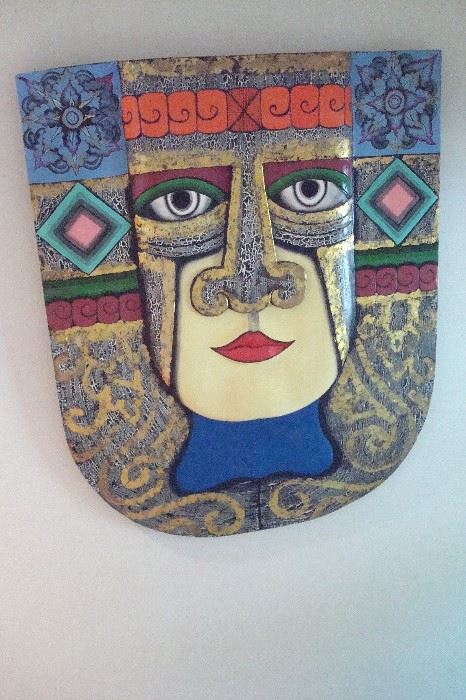 One of a pair of wooden hand carved mask wall hangings.