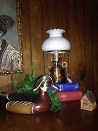 Wooden decoy and small brass lamp