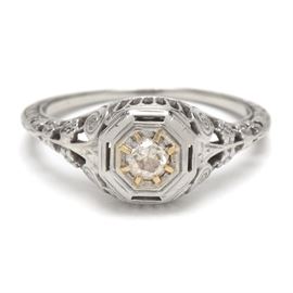 Edwardian 18K White Gold Filigree Diamond Engagement Ring: An Edwardian 18K white gold floral filigree ring showcasing a single diamond.