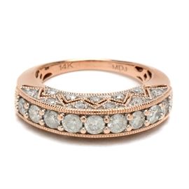 14K Rose Gold 1.04 CTW Diamond Ring: A 14K rose gold ring adorned with diamonds to all three sides of the high-arched, elongated crown.