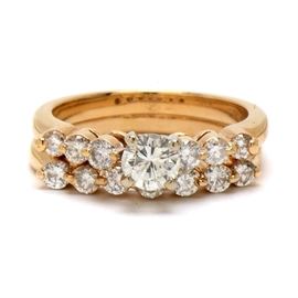 14K Yellow Gold Diamond Bridal Ring Set: A 14K yellow gold bridal ring set showcasing an engagement ring with a center diamond and a row of flanking diamonds including a complimentary wedding ring adorned with a row of seven diamonds. Total diamond carat weight is 0.90 ctw.
