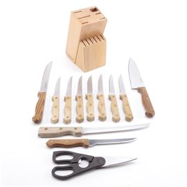 Farberware Knife Set: A stainless steel Farberware knife set. This set is housed in a wooden block with slots for each knife. Included in this set are seven steak knives, a fillet knife, Chef’s knife, kitchen shears, and more.