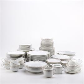 Antique Moritz Zdekauer Porcelain Tableware: A set of antique Moritz Zdekauer porcelain tableware. This ninety-eight piece set features ten dinner plates, eleven luncheon plates, twelve salad plates, eight bread and butter plates, seven appetizer plates, twelve soup bowls, nine cereal bowls, two dessert bowls, six cups, eleven saucers, a sugar bowl and creamer, a gravy boat with attached underplate, three oval serving bowls, two soup tureens, and two oval serving platters. Each piece is decorated with a border of pink roses and gilt trim. They are marked “M Z Austria” to their undersides.