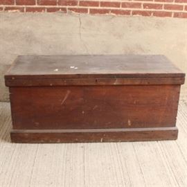 Early 20th Century Hope Chest: An early 20th century hope chest. This simple oak unit has a dark stain, hinged lid, and black metal handles. A skeleton key lock is present, but the key is not, and lid does not lock.
