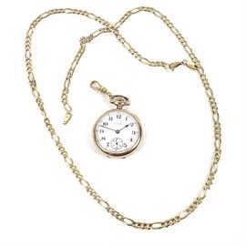 Elgin 10K Yellow Gold Pocket Watch and 14K Gold Filled Chain: An Elgin 10K yellow gold pocket watch and 14K yellow gold filled Figaro chain.