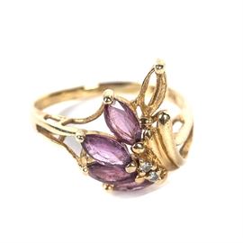 14K Gold Ring with Purple Amethyst Stones: A 14K yellow gold ring with marquise purple amethysts and round diamonds.